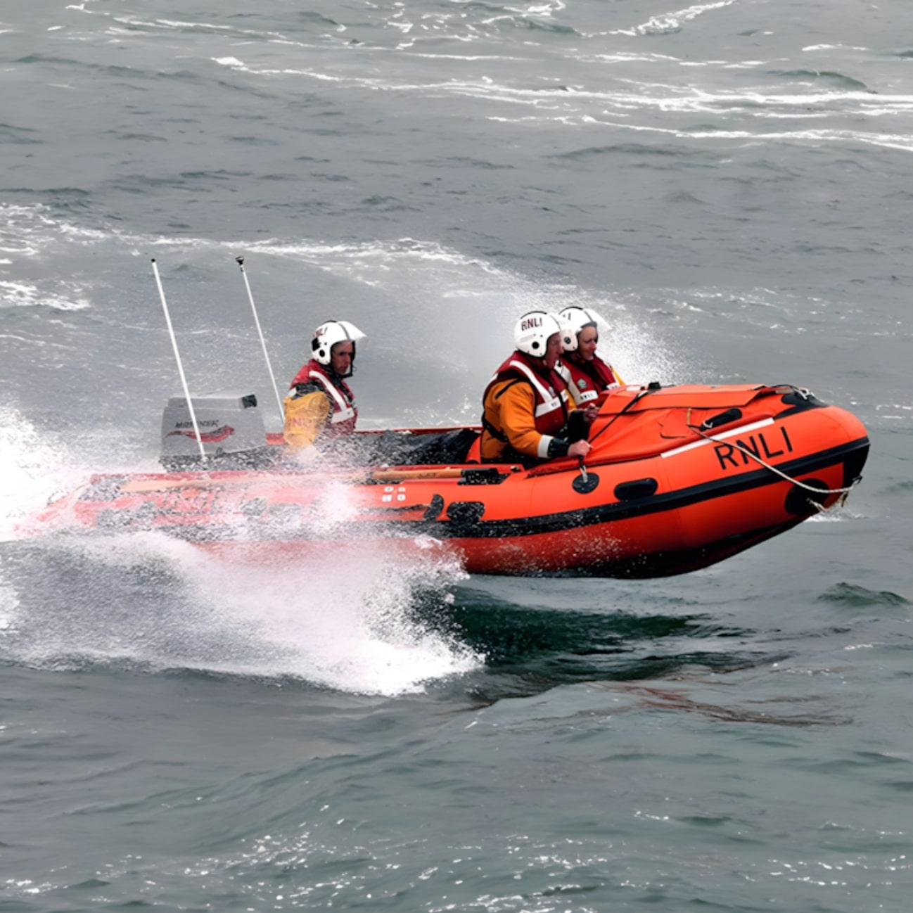 Three people ssailing on Stand-by Safety boat