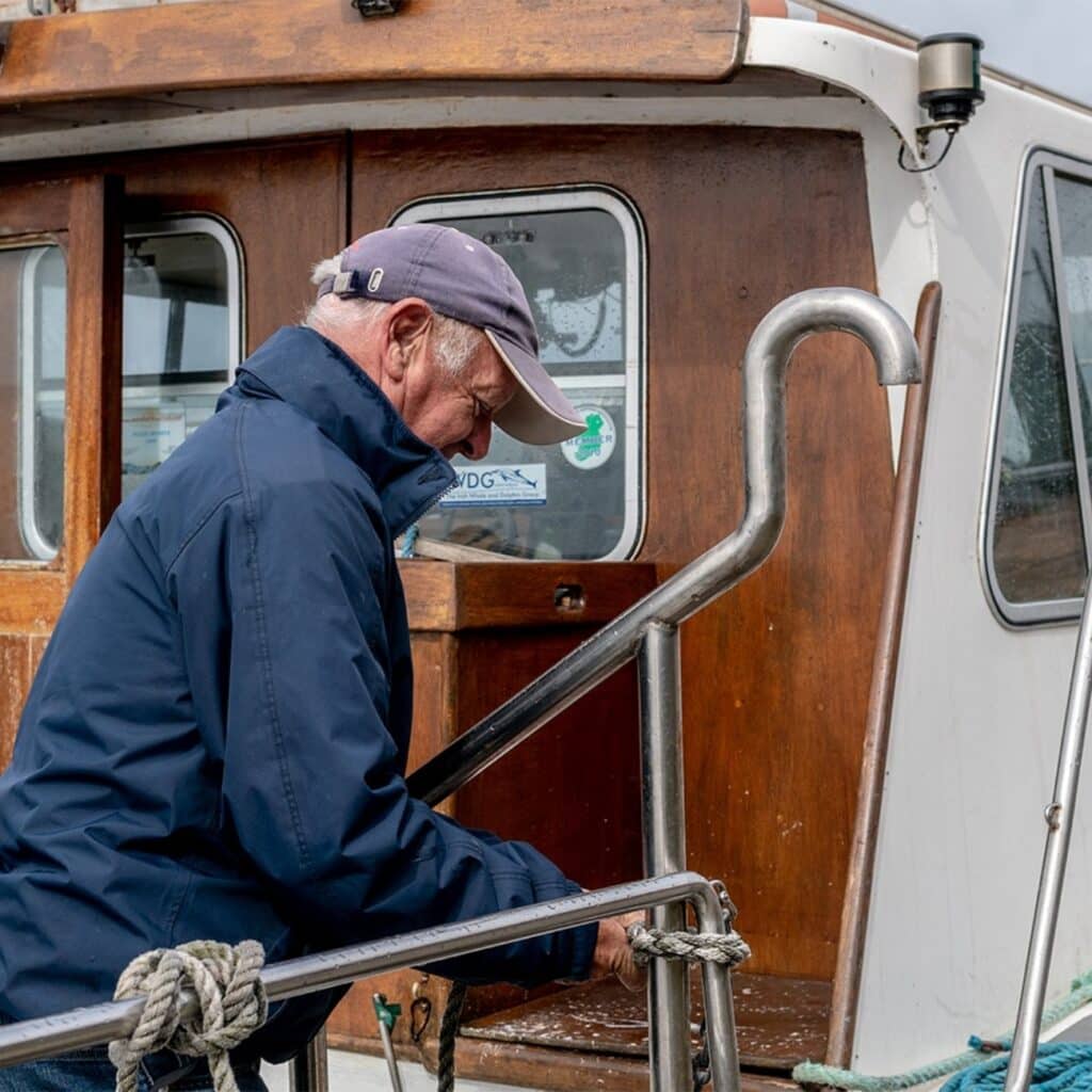 Walter tying a knot on the boat railing